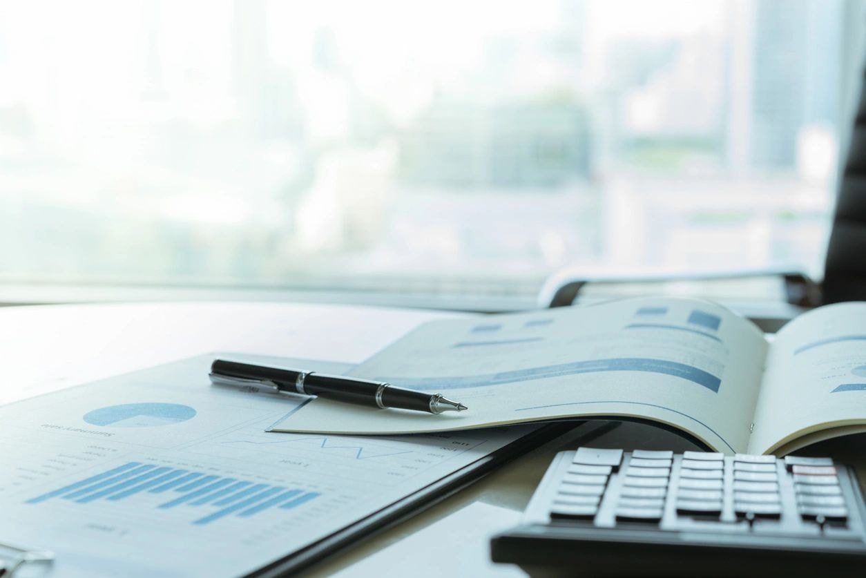 Professional business workspace with financial charts and city skyline
